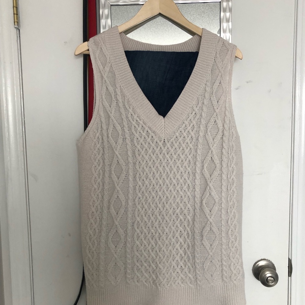 Cream sweater vest.